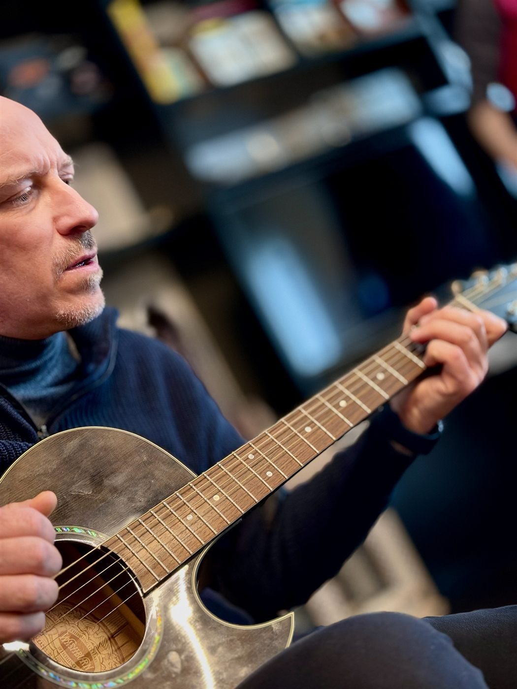 Giuliano playing an acoustic guitar